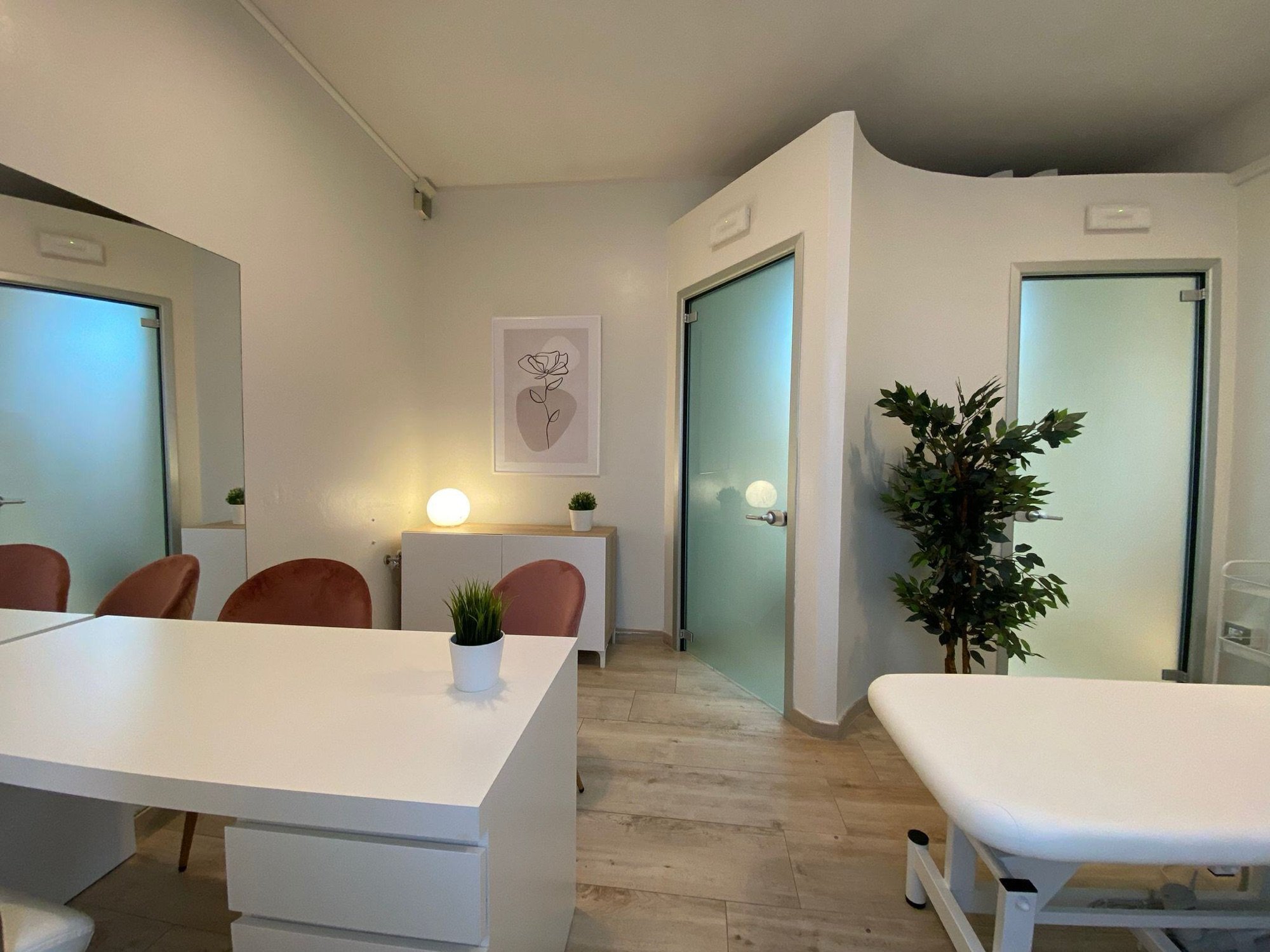 Tavolo colloquio con sedute e lettino vicino alla porta in studio olistico Exclusive presso Spatium Porta Romana, Firenze