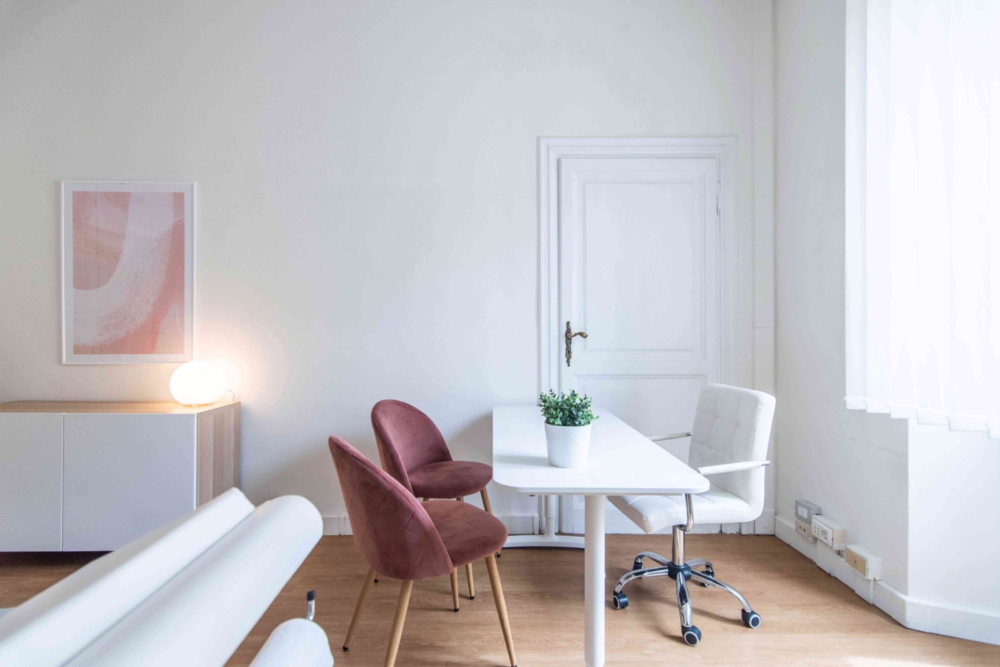 Tavolo colloquio con sedute rosa e mobile illuminato in studio olistico Top presso Spatium Parioli, Roma