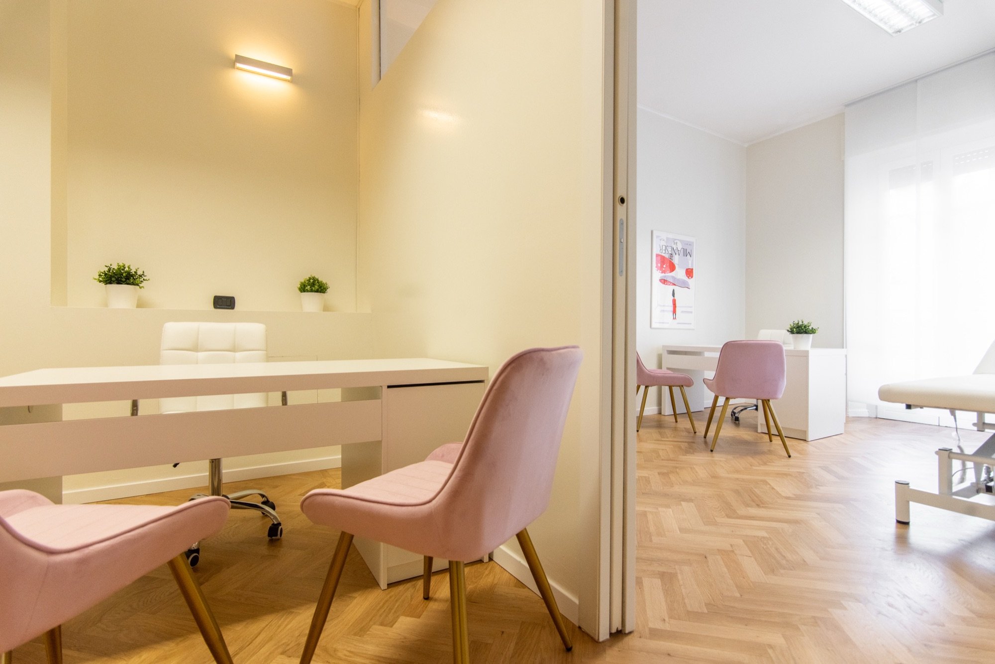 Area colloquio con poltroncina rosa e specchio, lettino sullo sfondo in studio professionale Lounge presso Spatium Santa Sofia, Milano