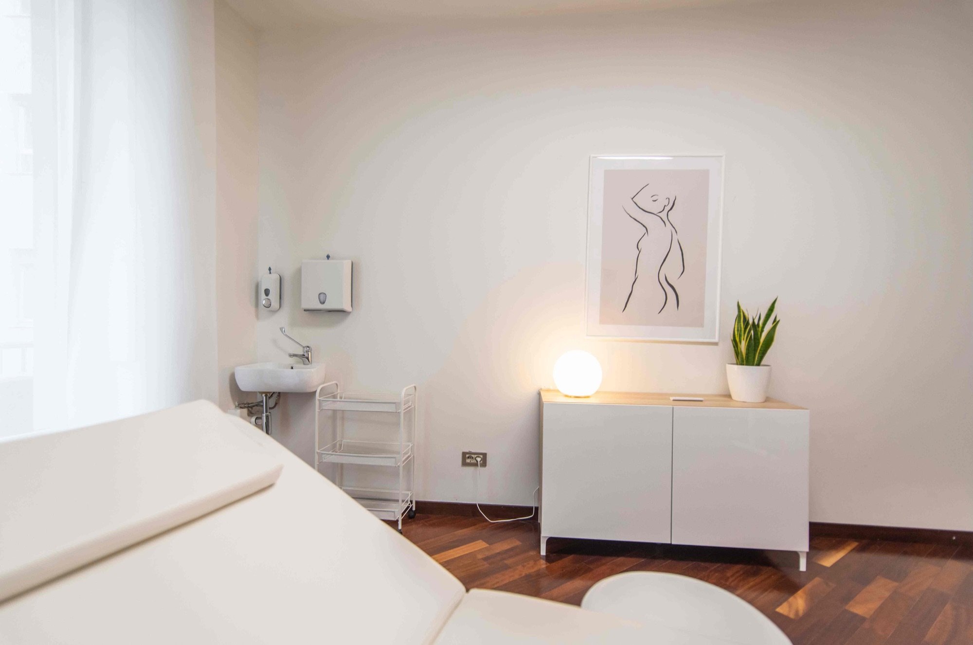Lettino da visita con lavabo e mobile illuminato in studio professionale Exclusive presso Spatium Duomo, Milano