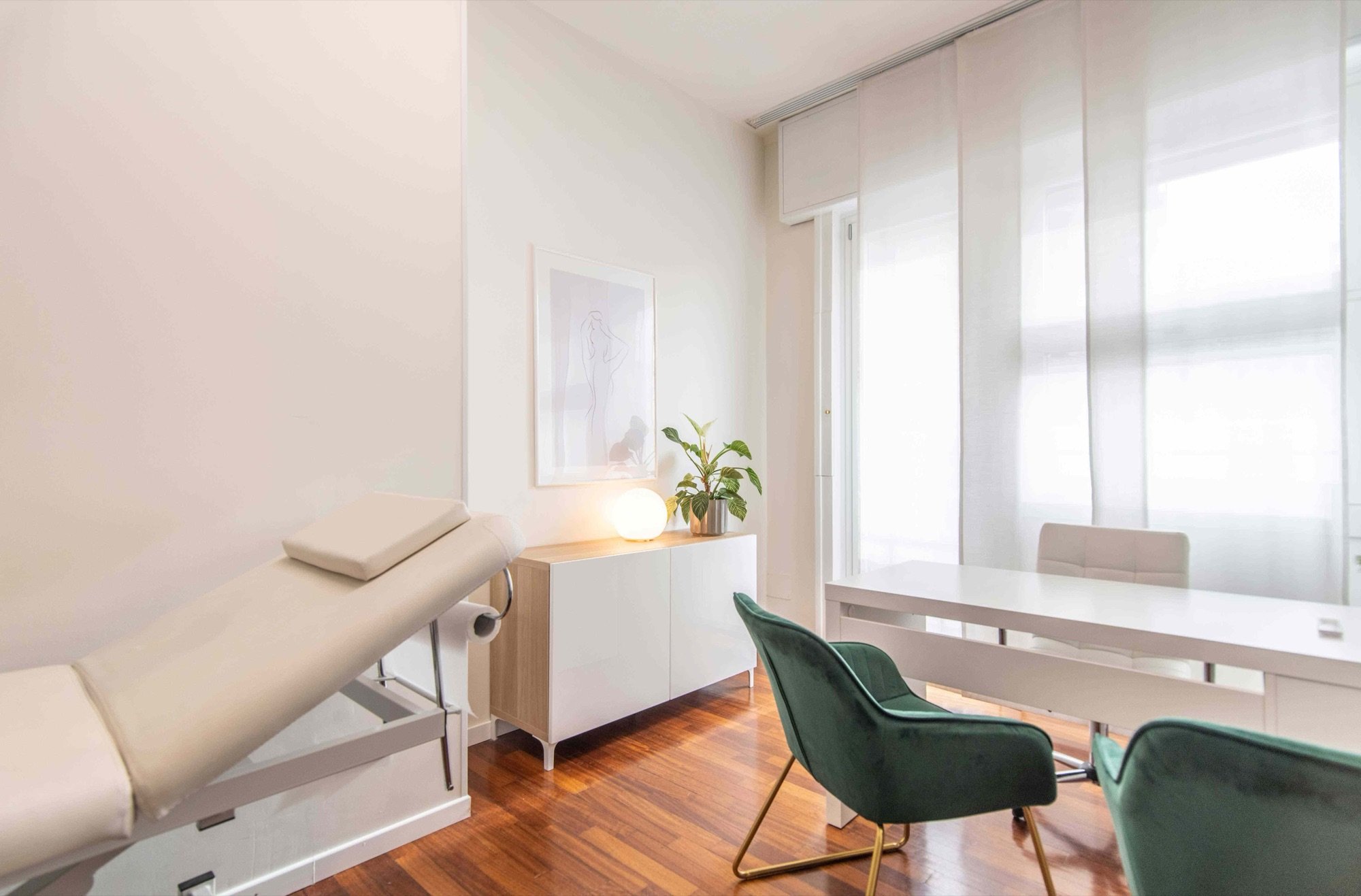 Lettino da visita con poltroncine verdi vicino alla finestra in studio professionale Top presso Spatium Duomo, Milano