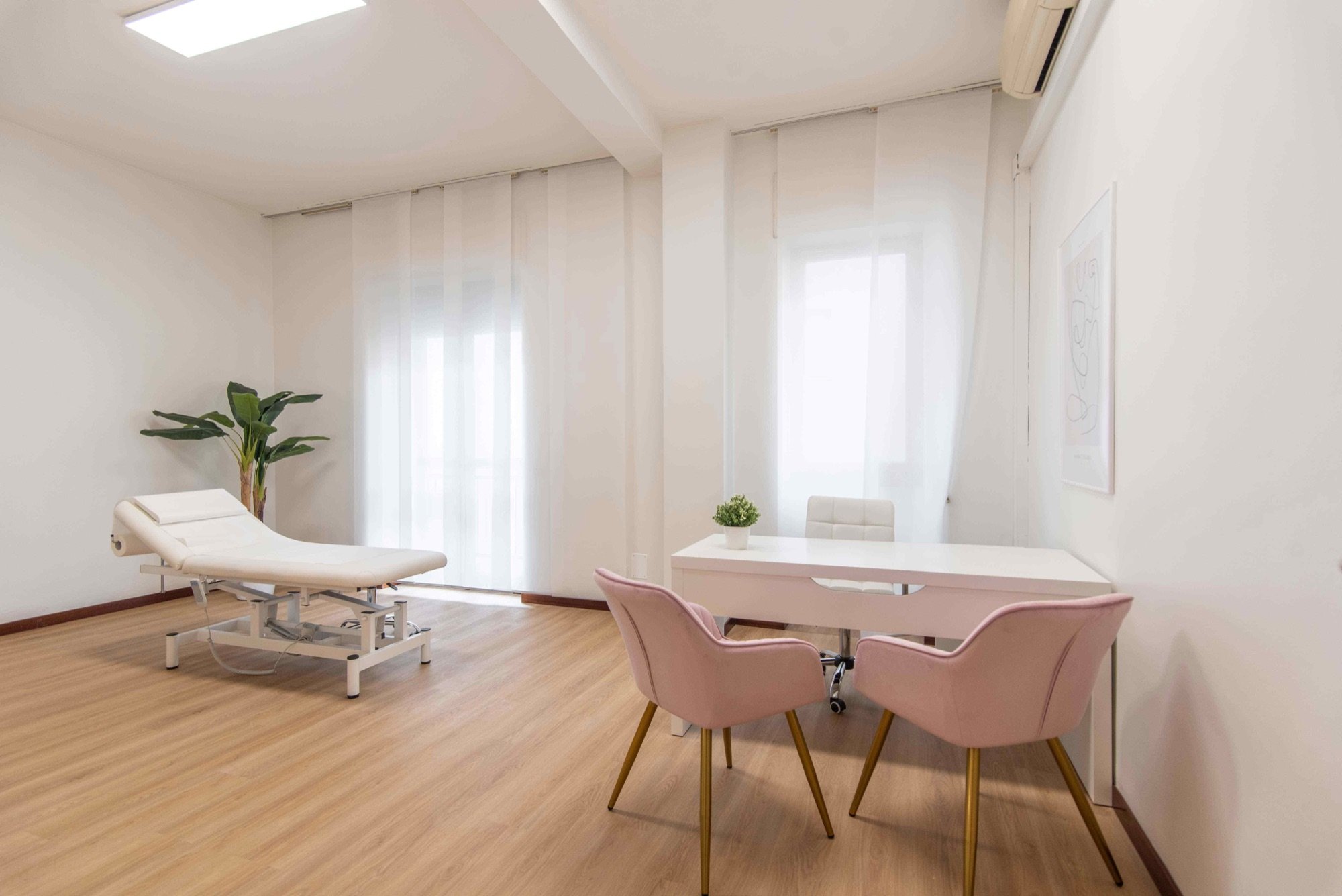 Lettino da visita con tavolo colloquio e sedute rosa in studio professionale Lounge presso Spatium Vittor Pisani, Milano