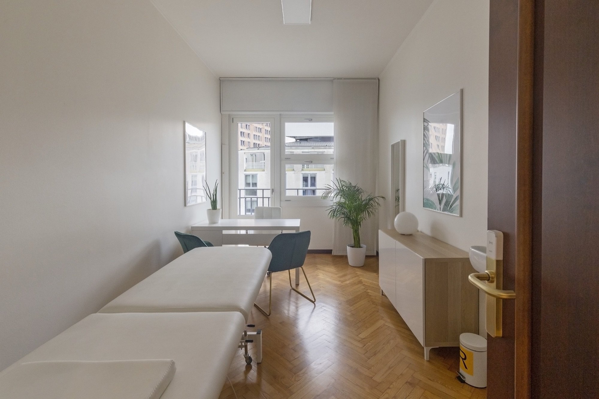 Lettino da visita con tavolo e poltroncine verdi in studio professionale Exclusive presso Spatium Duomo, Milano