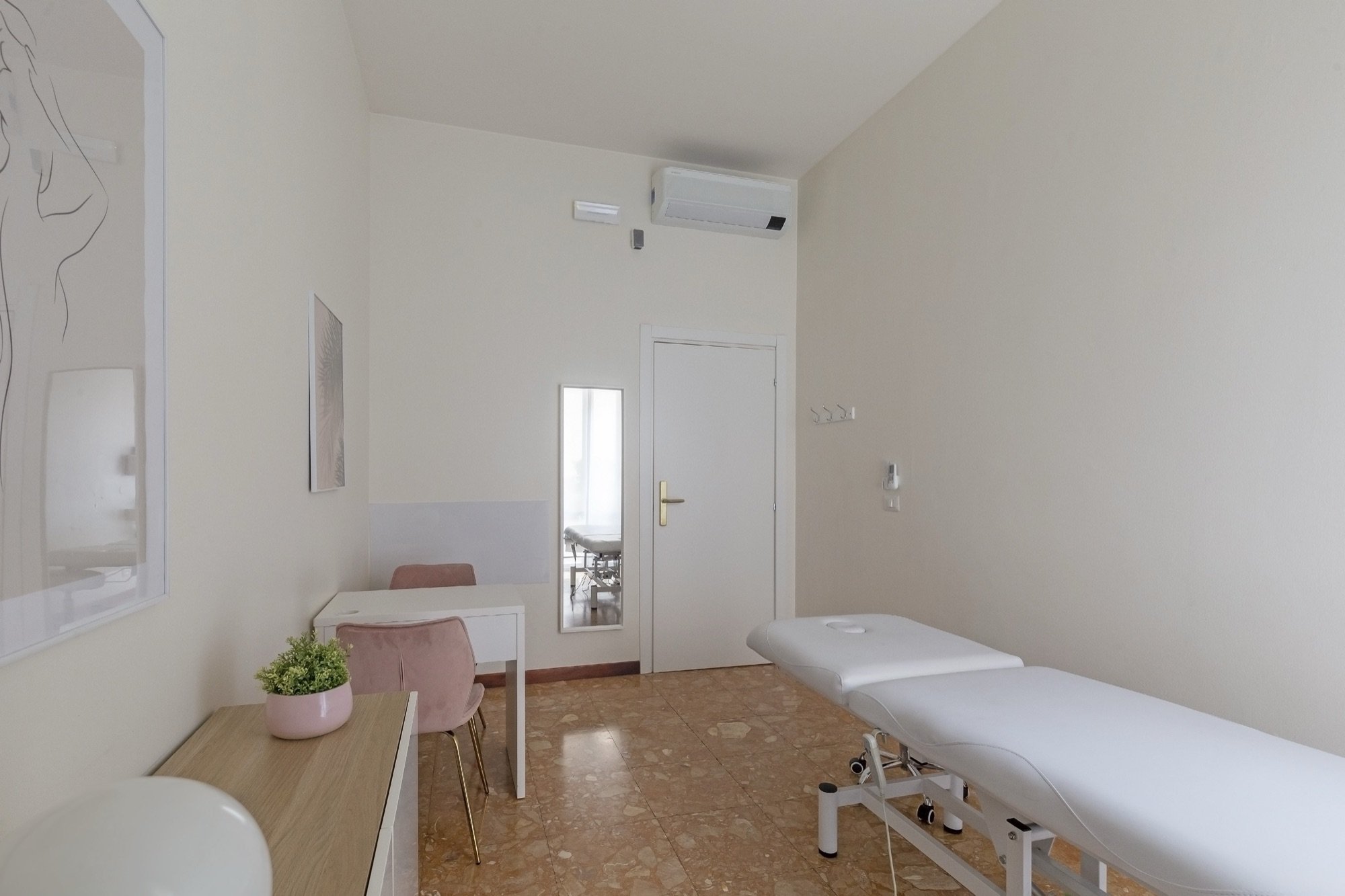 Vista longitudinale con lettino e scrivania in studio professionale Premium presso Spatium Repubblica, Milano
