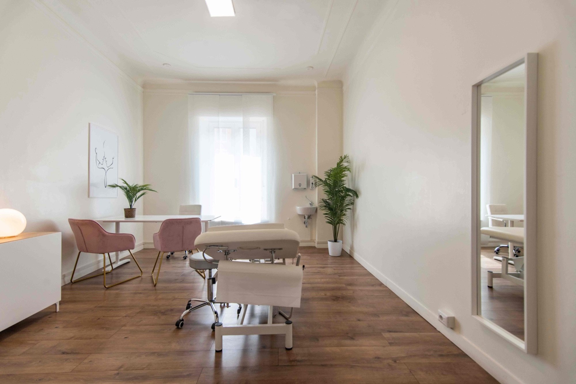 Vista longitudinale con lettino, tavolo e sedute in studio professionale Lounge presso Spatium Policlinico, Milano